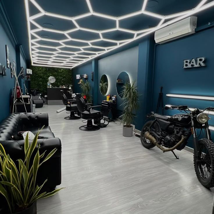 Modern barbershop with blue LED lighting, white and black walls, mirrors with blue frames and futuristic atmosphere